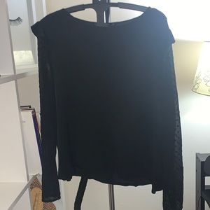 Black long sleeve blouse with ruffle detail.
